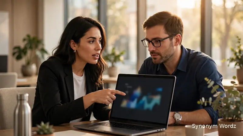 Professional asking a colleague for help in a modern office