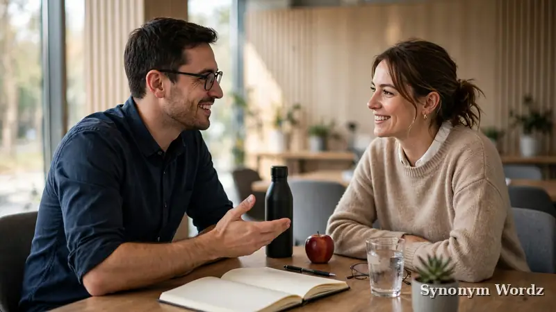 Two colleagues talking across a conference table in a meeting room, having an honest workplace conversation