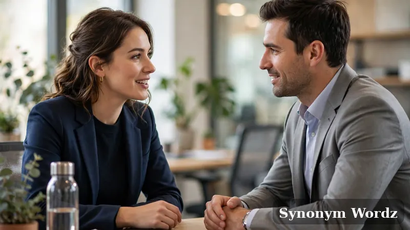 Two business professionals having a supportive and empathetic conversation across an office desk