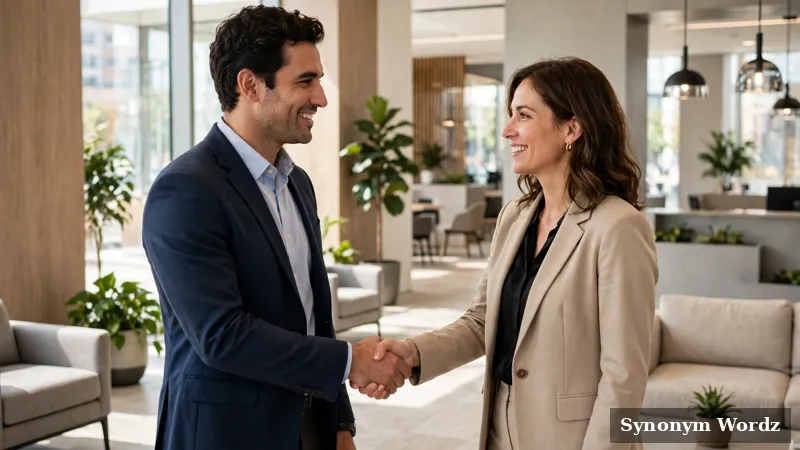 Two professionals networking and talking in a bright modern office lobby