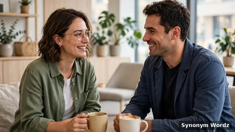 Two friendly colleagues having a collaborative conversation over coffee in a workplace lounge