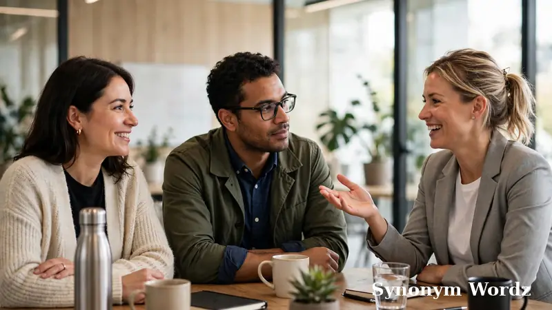 Three colleagues discussing professional phrase alternatives in a modern meeting room