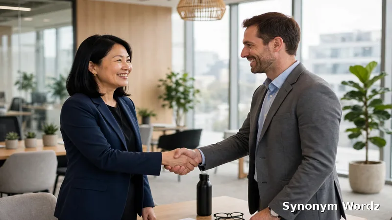 Two professionals shaking hands warmly in a bright modern office