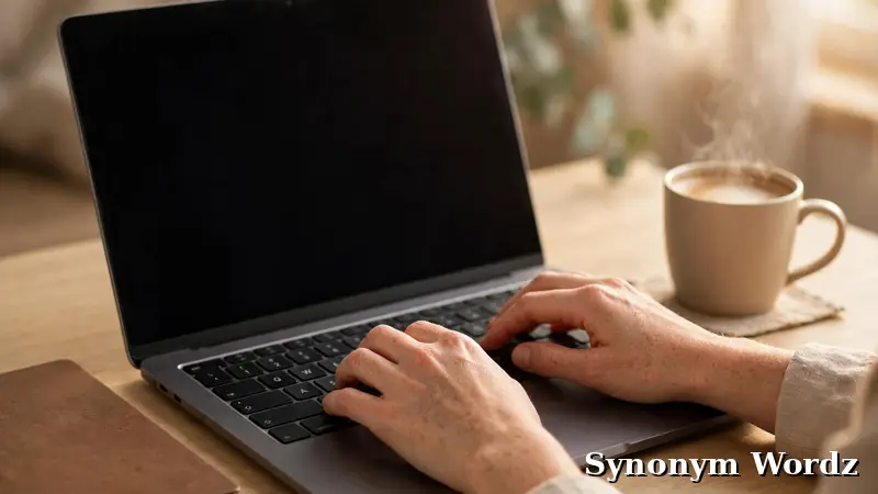 Professional typing a polished business email at an office desk
