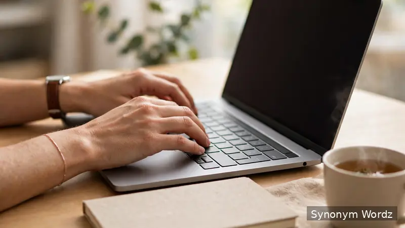 Person typing a professional follow-up email on a laptop at a bright tidy desk