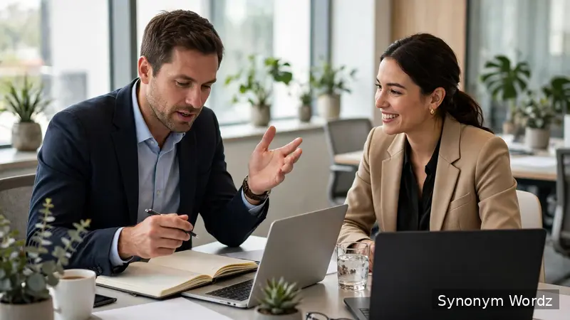 Two business colleagues discussing notes around a conference table in a bright modern office